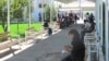 A crowd of people wait in line outside the offices of Turkmenistan's Migration Service in the eastern city of Turkmenabat in Lebap Province.