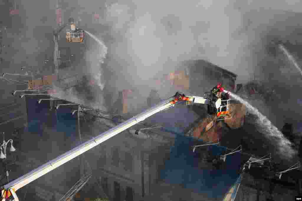Ukrainian firefighters extinguish a blaze in a three-story house on Khreshatyk Street, a main thoroughfare in Kyiv. (epa/Volodymyr Petrov)