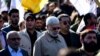 Former Iraqi militia commander Abu Mahdi al-Muhandis and Iraqi Shiite militia supporters march outside the U.S. Embassy during a protest in Baghdad, days before he was killed, 31 December 2019