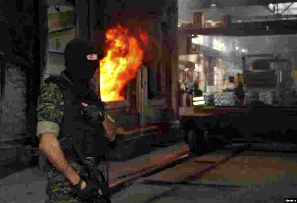 A member of Uzbekistan's security forces stands guard during an operation to destroy drugs at a metallurgical plant outside the capital, Tashkent, on June 25. (Reuters/Muhammad Sharif Mamatkulov)