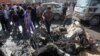 Iraqis inspect the site of a car bomb attack in Baghdad's impoverished district of Sadr City on February 17. 
