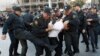 Police detain an opposition supporter in Baku in October 2013