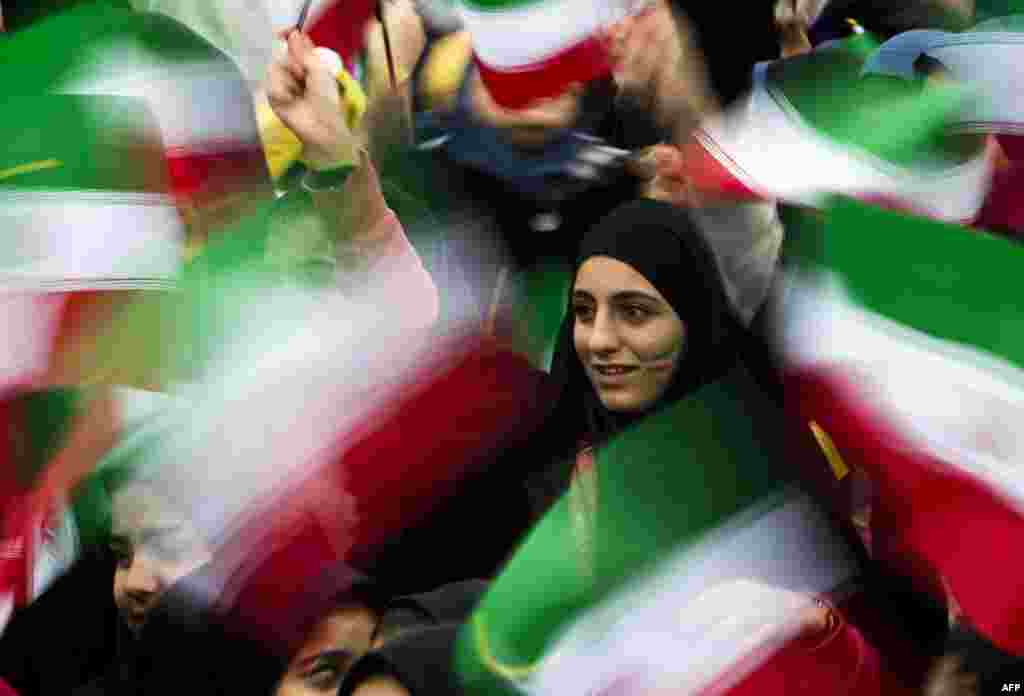Iranian students wave their national flag during the 36th anniversary of the Islamic Revolution on Tehran's Azadi Square (Freedom Square) on February 11. (AFP/Behrouz Mehri)