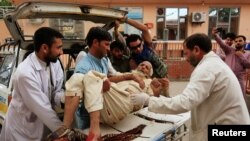 A wounded man is carried away from the site of the bombing.