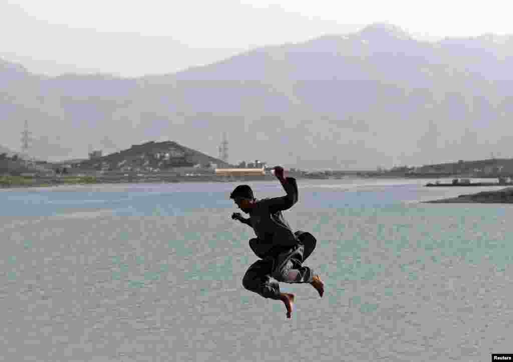 An Afghan boy plays on a trampoline along Qargha Lake on the outskirts of Kabul. (Reuters/Mohammad Ismail)