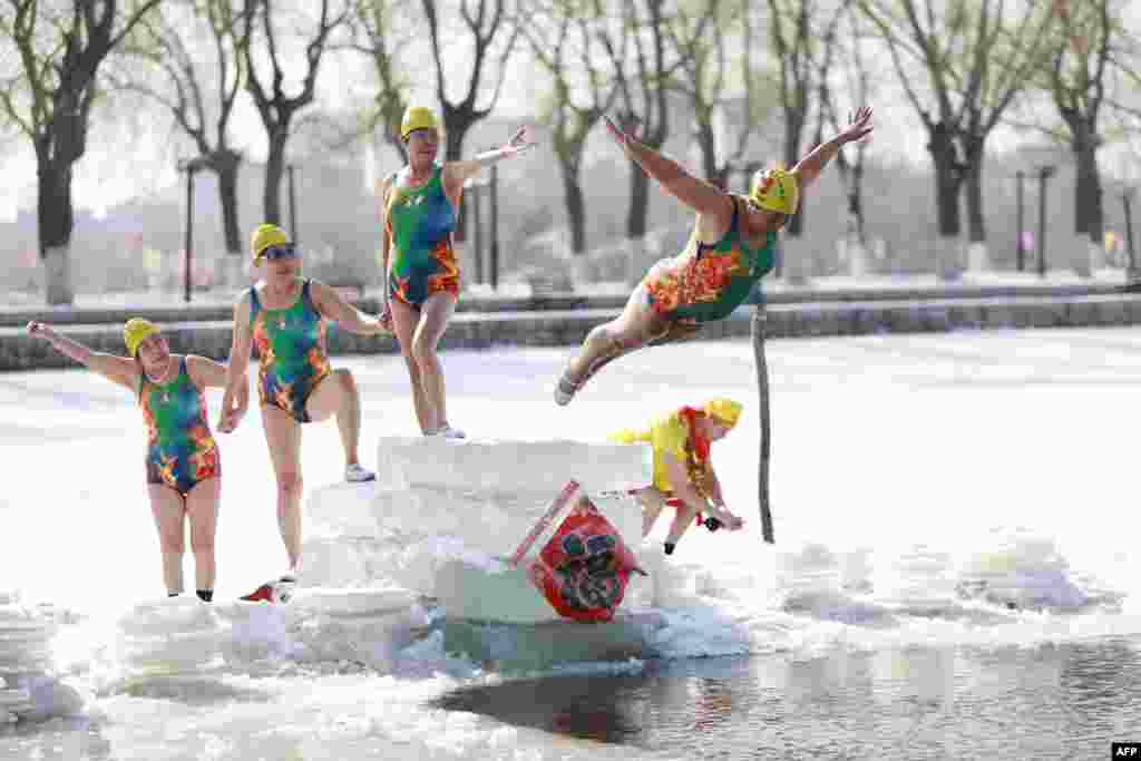 A woman dives into a partly frozen lake in Shenyang in China's northeastern Liaoning Province. (AFP)