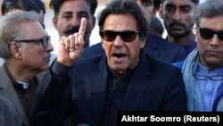 Imran Khan gestures as he addresses members of the media after Pakistan's Supreme Court dismissed a petition to disqualify him from parliament for not declaring assets, outside Jinnah International Airport in Karachi on December 15.