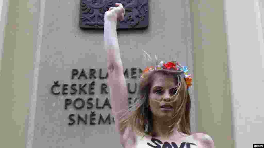Former Ukrainian adult film actress Anastasia Hrishay, also known as Wiska, attends a protest in front of the parliament building in Prague. Grishay, a mother of three, who was investigated by Ukrainian officials for the production and distribution of pornography in her home country, is under the threat of jail and deprivation of her maternity rights, according to local media. Grishay, who is supported by the women's rights group Femen, took part in the protest after Czech authorities rejected her asylum request. (Reuters/David W. Cerny)