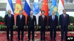 Shanghai Cooperation Organization leaders pose for a photo at a summit in Beijing in June.