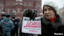 A participant holds up a flyer saying "We need Dozhd" during a protest against the threat of closure of Dozhd TV in Moscow in February.