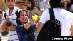 Young people fight with water guns in a park in Tehran last month.