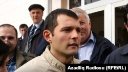 Adnan Hajizade speaks to reporters after being released from jail in Baku.