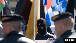 Russia -- Participants of Russian nationalist march on May Day, wearing face masks, 01May2009 