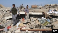 Palestinians sift though destroyed buildings following Israeli air strikes in Rafah, southern Gaza Strip, on January 5.