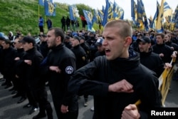 Members of the Azov Battalion attend a protest against local elections in separatist-held areas of eastern Ukraine in Kyiv on May 20, 2016.