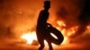 A demonstrator burns tires during protests in the southern Iraqi city of Basra on July 12. 