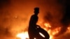 A demonstrator burns tires during an ongoing protest against unemployment and the high cost of living in the southern Iraqi city of Basra. (AFP/Haidar Mohammed Ali)