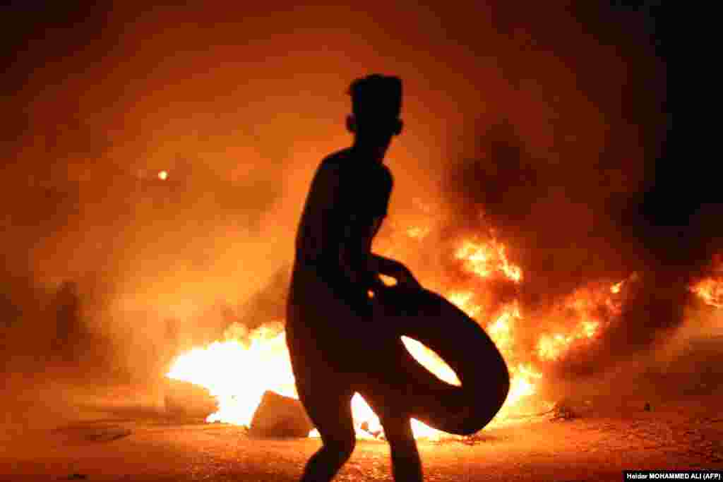 A demonstrator burns tires during an ongoing protest against unemployment and the high cost of living in the southern Iraqi city of Basra. (AFP/Haidar Mohammed Ali)