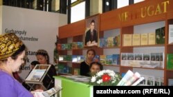 A portrait of the Turkmen president looms over attendees of the international book fair in the capital, Ashgabat.