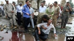 A man grieves following a suicide bombing outside the Baghdad provincial governorate in central Baghdad on October 25.