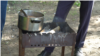 "We chip in 50 or 100 rubles each to feed the kids when they return from school," a man says as he stirs a pot of buckwheat in the courtyard.