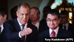 Russian Foreign Minister Sergei Lavrov (left) welcomes his Japanese counterpart Taro Kono during a meeting in Moscow on July 31, 2018.