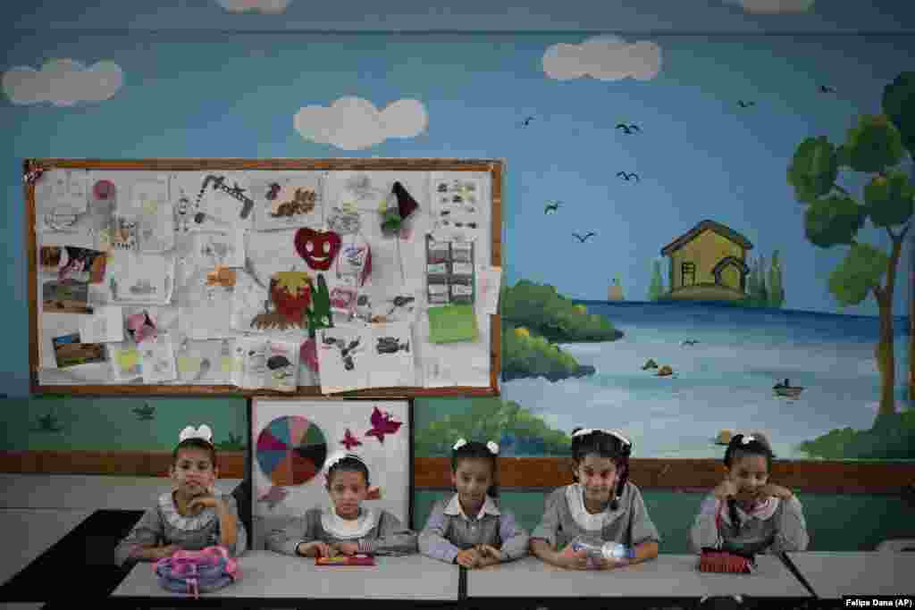Girls sit inside a classroom during the first day of a new school year in Gaza City. Hundreds of thousands of Palestinian children are starting their school year in the Gaza Strip amid a major budget crunch for the United Nations agency that funds many schools. (AP/Felipe Dana)
