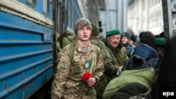 Relatives and friends meet returning Ukrainian soldiers in Lviv on February 23. 