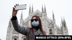 Селфі під час пандемії коронавірсу на тлі Міланського собору. Італія. Березень 2020 року.