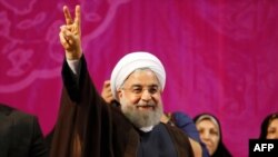 Iranian President Hassan Rohani gestures during a campaign rally in Tehran, May 9, 2017