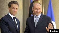 France -- President Nicolas Sarkozy (L) greets Mustafa Abdel Jalil, head of the main Libyan rebel council, as he arrives for a meeting in Paris, 20Apr2011