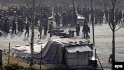 Indian army soldiers stand near the bodies of suspected militants after a clash in Kashmir, December, 2014.