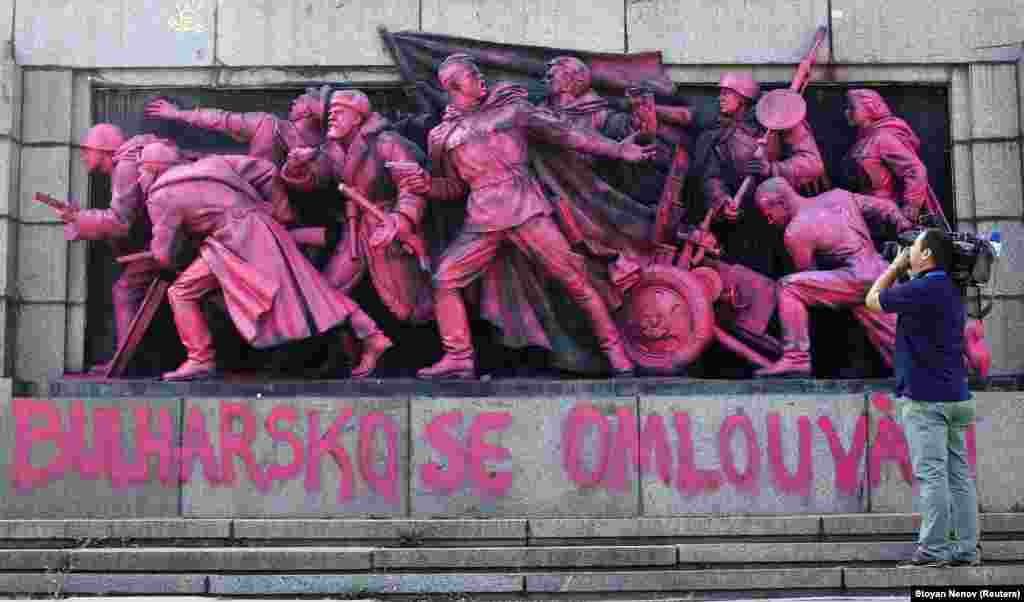 A cameraman films the figures of Soviet soldiers at the base of the Soviet Army monument, painted pink, in Sofia. Unknown artists painted the nine soldiers pink during the night on August 21 and wrote &quot;Bulgaria apologizes&quot; in both in the Bulgarian and Czech languages in what appears to be an artistic apology for Bulgaria&#39;s support in smashing the Prague Spring uprising against communist rule on August 20-21,1968. (Reuters/Stoyan Nenov)