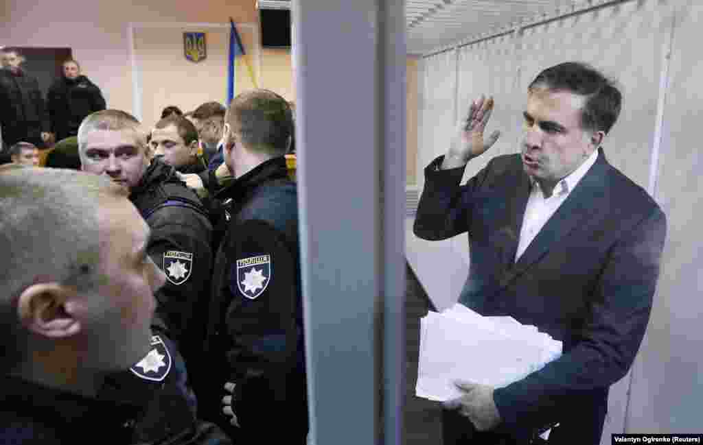 Ukrainian opposition figure and former Georgian President Mikheil Saakashvili,&nbsp;accused by prosecutors of assisting a criminal organization, gestures inside the defendants&#39; cage as he attends a court hearing in Kyiv on December 11. A Ukrainian court released Saakashvili from detention. (Reuters/Valentyn Ogirenko)