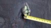 AT SEA -- This image released by the U.S. Department of Defense on June 17, 2019, according to the Navy, shows the aluminum and green composite material left behind following removal of an unexploded limpet mine used in an attack on the starboard side of 