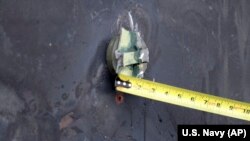 AT SEA -- This image released by the U.S. Department of Defense on June 17, 2019, according to the Navy, shows the aluminum and green composite material left behind following removal of an unexploded limpet mine used in an attack on the starboard side of 