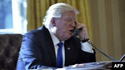U.S. President Donald Trump speaking on the phone with Russian President Vladimir Putin.
