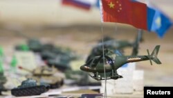 Miniatures depicting troops of different nations sit on a plan for SCO military exercises in 2010.