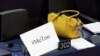 A placard with the hashtag "MeToo" is seen on a European Parliament member's desk