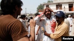 A man cries over the death of his brother at the site of a suicide blast at a church in Peshawar on September 22. 