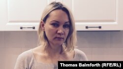 Yelena Balanovskaya stands in the newly decorated kitchen of the apartment that she bought with a dollar mortgage that she's now struggling to pay off because of the ruble crisis.