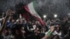 Supporters of newly re-elected Iranian President Hassan Rouhani dance during a gathering to celebrate his victory on Vanak square in downtown Tehran, May 20, 2017