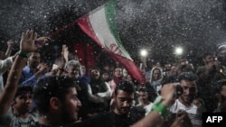 Supporters of newly re-elected Iranian President Hassan Rouhani dance during a gathering to celebrate his victory on Vanak square in downtown Tehran, May 20, 2017