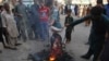 Pakistani protesters burn a poster image of Christian woman Asia Bibi in the southern city of Hyderabad on November 1.