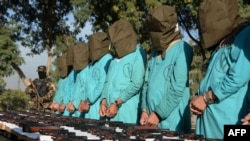 Suspected Islamic State (IS) and Taliban militants are brought before media during a press conference in Jalalabad on December 6, 2016.