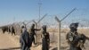 Iraqi SWAT forces stand guard outside Camp Ashraf