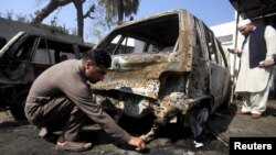 A policeman looks for evidence after a suicide attack in the courthouse of Shabqadar, near Peshawar, on March 7.