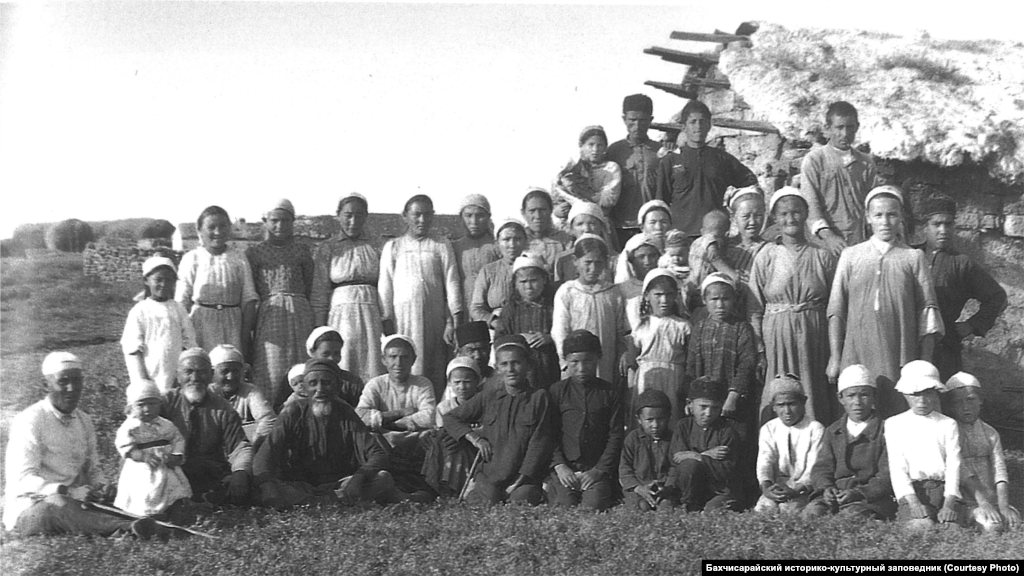 Villagers pose on the Crimean steppe, where cattle breeding was combined with agriculture. The time for planting and harvesting was determined by the elders. A Crimean Tatar proverb says, &quot;To mow is to swing, to reap is to squat, but only cheese is pressed in the pasture&rdquo; meaning that the work of the farmer was considered more difficult than the work of a herder.
