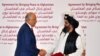 U.S. Special Representative for Afghanistan Reconciliation Zalmay Khalilzad and Taliban co-founder Mullah Abdul Ghani Baradar shake hands after signing a peace agreement during a ceremony in the Qatari capital Doha on February 29.