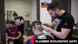 SERBIA -- Serbian hairdresser Mario Hvala creates a hair tattoo showing the portrait of Argentinian football player Lionel Messi on the head of a football fan in Novi Sad, Serbia, on June 10, 2018.